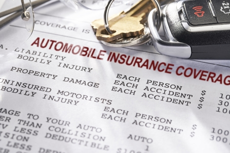 auto insurance document with car keys