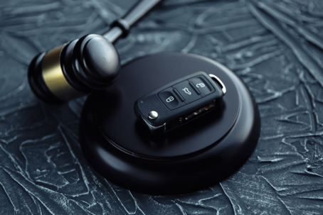 gavel and car key on the wooden desk