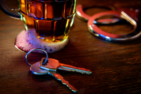 Mug of beer with handcuffs and keys
