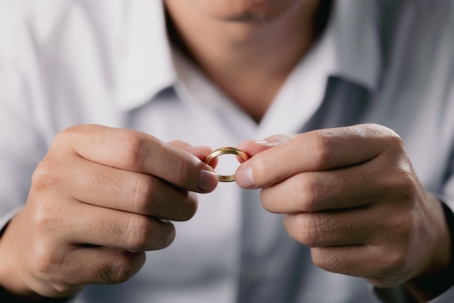 Close-up of man holding ring at home