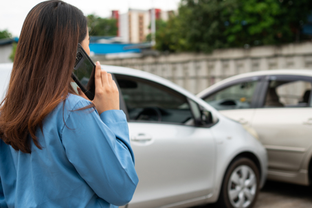 woman makes call after a car accident