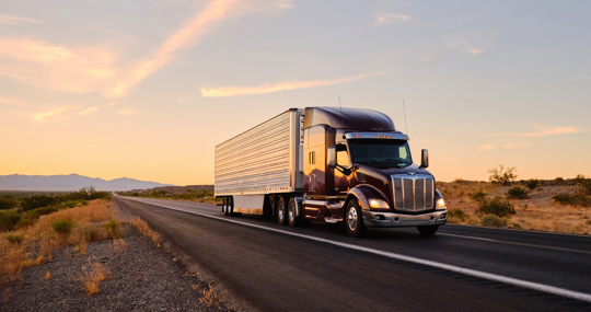 Large semi truck hauling freight on the open highway