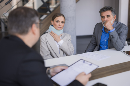 Injured woman and man consulting with a lawyer