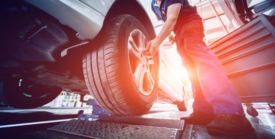 mechanic fixing a car tire