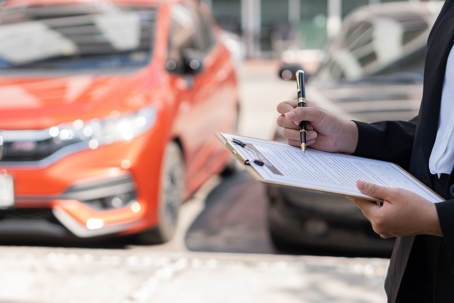 insurance adjuster reviewing a car accident claim paperwork