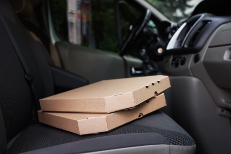 Pizza boxes in courier car