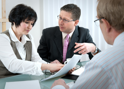 woman and her lawyer in conversation with husband during divorce process