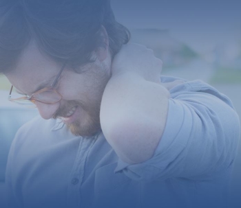 man rubbing his injured neck